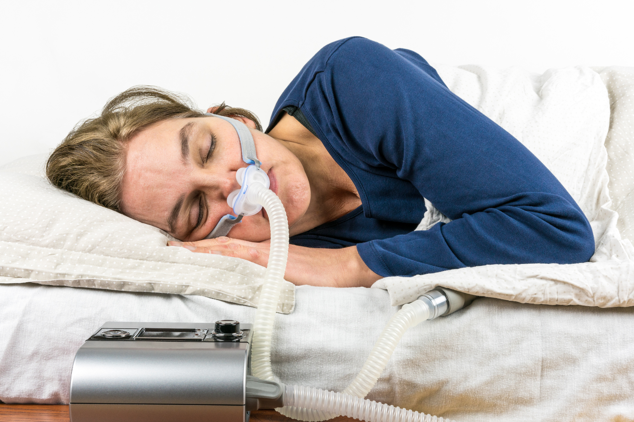 Patient wearing a CPAP mask during sleep apnea therapy